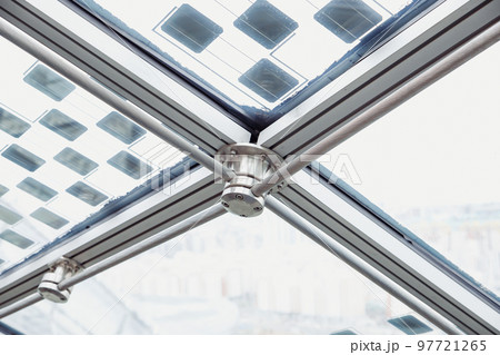 Glass roof with solar panels, metal steel mount of glass cupola, steel rope, futuristic Interior, close-up. 97721265