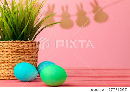 Colored eggs for Easter with pot of artificial grass 97721267