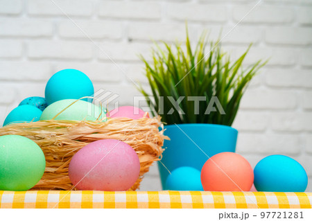 Easter decorative nest with colored eggs close up 97721281