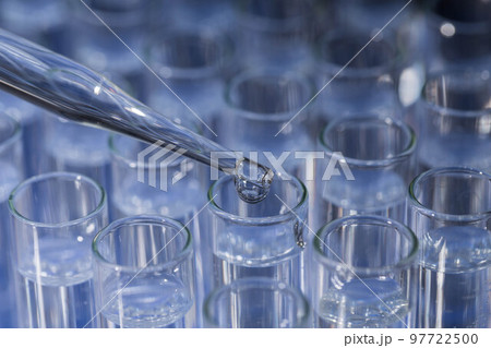 Pipette dropping fluid into test tube Pipette dropping fluid into test tube 97722500