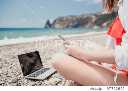 Woman sea laptop. Business woman working on laptop by sea at sunset. Close up on hands of pretty lady typing on computer outdoors summer day. Freelance, digital nomad, travel and holidays concept. Woman sea laptop. Business woman working on laptop by sea at sunset. Close up on hands of pretty lady typing on computer outdoors summer day. Freelance, digital nomad, travel and holidays concept. 97722693
