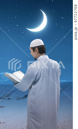 Muslim man standing and reading the Quran Muslim man standing and reading the Quran 97722768