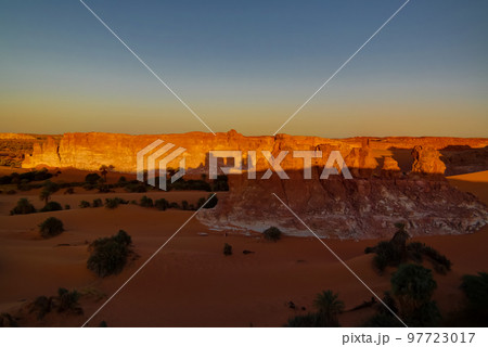Sunrise at sandstone formation in the Sahara desert near Yoa Lake group of Ounianga Kebir, Ennedi, Chad Sunrise at sandstone formation in the Sahara desert near Yoa Lake group of Ounianga Kebir, Ennedi, Chad 97723017