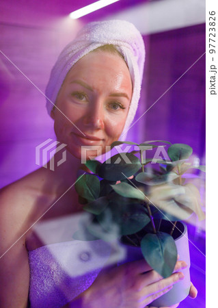 A girl takes care of her face and skin after a shower. 97723826