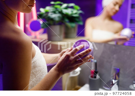 A girl takes care of her face and skin after a shower. A girl takes care of her face and skin after a shower. 97724058