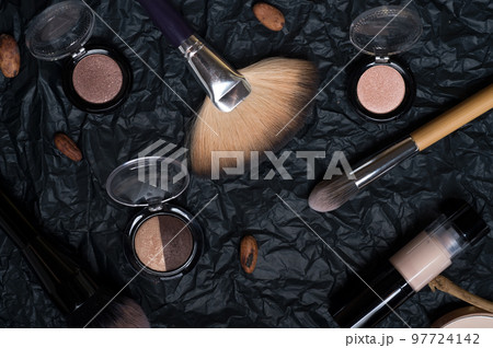 set of cosmetics and nature chocolate on black background set of cosmetics and nature chocolate on black background 97724142