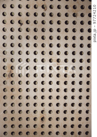 Wooden wall with round holes. Texture, pattern, background. Element of soundproof room in broadcast and sound recording studio 97724210