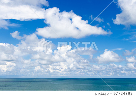 Beautiful calm turquoise color sea and blue sky with white color cloud background 97724395
