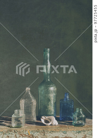 Still life with glass bottles of various shapes. art photography 97725455