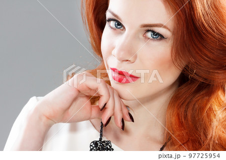 Long Curly Red Hair. Fashion Woman Portrait. Beauty Model Girl with Luxurious Hair, Make up and Accessories. Hairstyle. Wavy Hair Extensions Concept. Holiday Makeup. Smoky eyes and Red lipstick Long Curly Red Hair. Fashion Woman Portrait. Beauty Model Girl with Luxurious Hair, Make up and Accessories. Hairstyle. Wavy Hair Extensions Concept. Holiday Makeup. Smoky eyes and Red lipstick 97725954