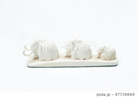 Mammoth family sculpture from white old bone isolated on white background. Side view 97726669