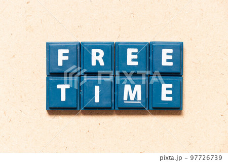 Tile letter in english word free time on wood background Tile letter in english word free time on wood background 97726739