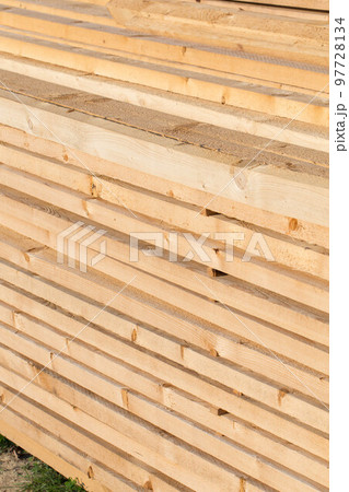 Stacked lumber background 97728134