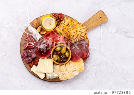 Antipasto board with prosciutto, salami, crackers, cheese Antipasto board with prosciutto, salami, crackers, cheese 97728399