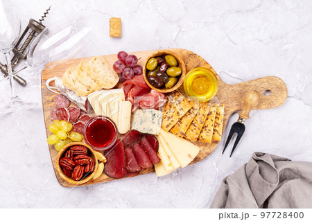 Antipasto board with prosciutto, salami, crackers, cheese 97728400