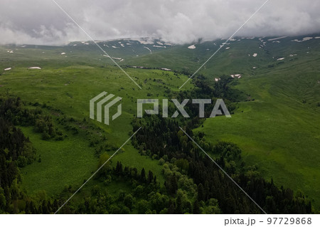 Beautiful mysterious landscape with green valley and cloudy sky in Lago-Naki Beautiful mysterious landscape with green valley and cloudy sky in Lago-Naki 97729868