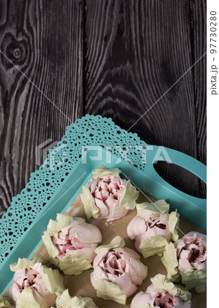 Zephyr tulips. Natural homemade marshmallow. Arranged on a tray. Close-up. Zephyr tulips. Natural homemade marshmallow. Arranged on a tray. Close-up. 97730280
