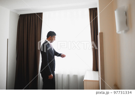 Beautiful man, groom posing and preparing for wedding 97731334