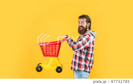 man go shopping. funny man with small shopping cart. weekend on buying products. rejoices successful purchases. brutal mature hipster go shopping. Its time to fill the cart man go shopping. funny man with small shopping cart. weekend on buying products. rejoices successful purchases. brutal mature hipster go shopping. Its time to fill the cart 97732785