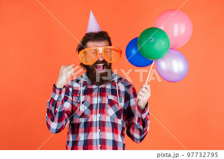 Carefree fun. having fun with balloons. prepare for anniversary. best event manager. brutal male on party. funny man in birthday hat. happy holiday celebration. party goer going crazy Carefree fun. having fun with balloons. prepare for anniversary. best event manager. brutal male on party. funny man in birthday hat. happy holiday celebration. party goer going crazy 97732795
