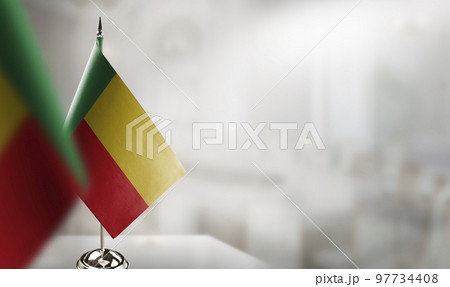 Small flags of the Benin on an abstract blurry background 97734408