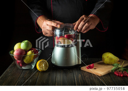 Professional chef prepares sweet fruit drink in a blender or mixer. Menu or recipe idea for a healthy vegetarian breakfast or dinner Professional chef prepares sweet fruit drink in a blender or mixer. Menu or recipe idea for a healthy vegetarian breakfast or dinner 97735058