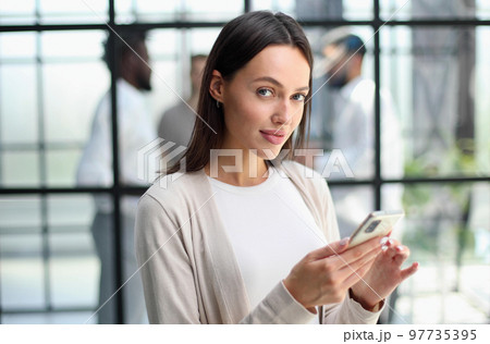 Businesswoman with phone in modern office Businesswoman with phone in modern office 97735395
