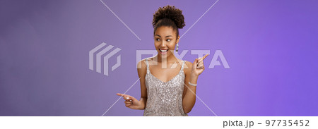 Good-looking excited glamour african-american female student attend luxurious event in silver shiny perfect dress dancing look around pointing right left smiling pleased variants make choice Good-looking excited glamour african-american female student attend luxurious event in silver shiny perfect dress dancing look around pointing right left smiling pleased variants make choice 97735452