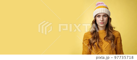 Close-up worried upset attractive young 20s woman look serious nervous sympathizing you listening terrible upsetting story standing yellow background looking camera, wearing hat sweater Close-up worried upset attractive young 20s woman look serious nervous sympathizing you listening terrible upsetting story standing yellow background looking camera, wearing hat sweater 97735718