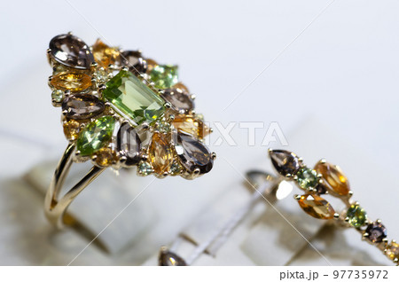 jewelry retail store showcase displaying white gold ring  with precious  gemstones. ring with emeralds, topazes, citrenes. close up jewelry retail store showcase displaying white gold ring  with precious  gemstones. ring with emeralds, topazes, citrenes. close up 97735972