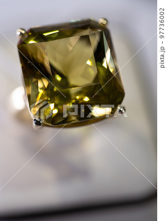 jewelry retail store showcase displaying white gold rings with big citrine gemstone. macro shot jewelry retail store showcase displaying white gold rings with big citrine gemstone. macro shot 97736002