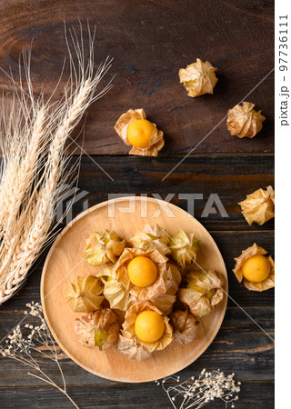 Cape gooseberry or golden berry (Physalis peruviana) on wooden background, Table top view 97736111