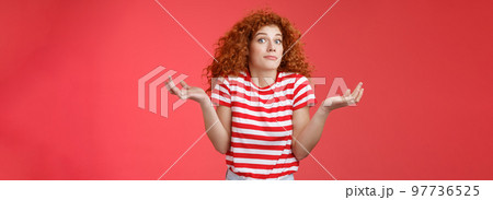 Not know ask someone else. Clueless unaware cute redhead curly-haired charming modern girl uncertain where spend summer holidays shrugging hands spread sideways smirking confused red background Not know ask someone else. Clueless unaware cute redhead curly-haired charming modern girl uncertain where spend summer holidays shrugging hands spread sideways smirking confused red background 97736525
