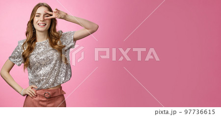 Stylish confident sassy caucasian female wearing glamour glittering blouse skirt show-off make disco peace gesture victory sign near eye smiling self-assured, posing arrogant cheeky pink background Stylish confident sassy caucasian female wearing glamour glittering blouse skirt show-off make disco peace gesture victory sign near eye smiling self-assured, posing arrogant cheeky pink background 97736615