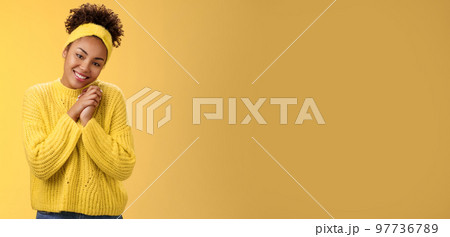Touched tender african-american woman press palms together sighing happily smiling enjoying lovely scene grinning look passionate delighted grateful have united supportive family, yellow background Touched tender african-american woman press palms together sighing happily smiling enjoying lovely scene grinning look passionate delighted grateful have united supportive family, yellow background 97736789