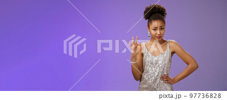 Doubtful suspicious clever african-american young woman in silver dress deal cover friend show okay ok confirmation gesture smirking frowning unsure questioned express disbelief hesitation Doubtful suspicious clever african-american young woman in silver dress deal cover friend show okay ok confirmation gesture smirking frowning unsure questioned express disbelief hesitation 97736828
