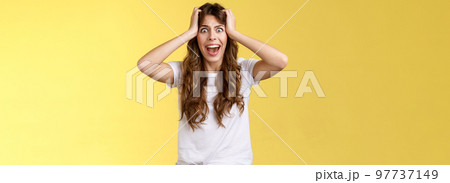 Girl screaming panic. Troubled distressed anxious woman see huge mess terrified feel sorrow shouting shocked grab head hopeless problem terrible situation yelling shook stunned yellow background 97737149