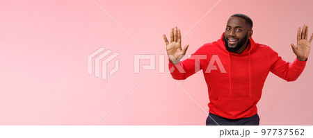 Happy charming outgoing african american male model raise hands joking standing surrender smiling give up girlfriend won grinning agree go dinner restaurant, standing pink background Happy charming outgoing african american male model raise hands joking standing surrender smiling give up girlfriend won grinning agree go dinner restaurant, standing pink background 97737562