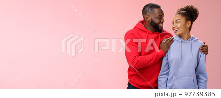 Charming lovely couple in love relationship support each other look caring passionate eyes smiling broadly heartwarming confession boyfriend hugging girlfriend feel secure, standing pink background 97739385