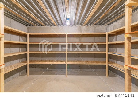 Unfinished food storage at the basement with concrete walls 97741141
