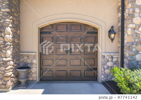 Garage exterior of a house with french style dark wood doors 97741142
