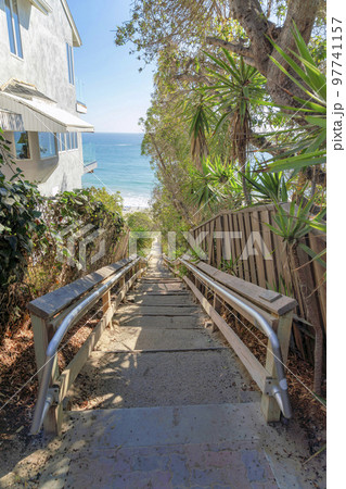 Stairs wooden railings and metal handrail bars heading to the beach at San Clemente, California 97741157