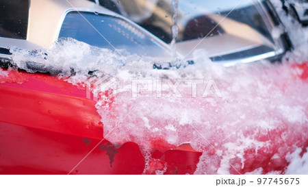 Close-up of snow frozen on a car. The concept of weather conditions Close-up of snow frozen on a car. The concept of weather conditions 97745675