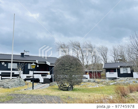 A view of red wooden houses on Vrango Archipelago island . A view of red wooden houses on Vrango Archipelago island . 97745978