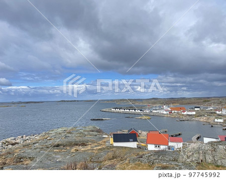 A view of red wooden houses on Vrango Archipelago island . 97745992