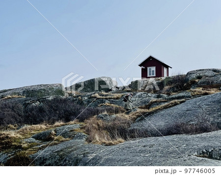 A view of red wooden houses on Vrango Archipelago island . 97746005