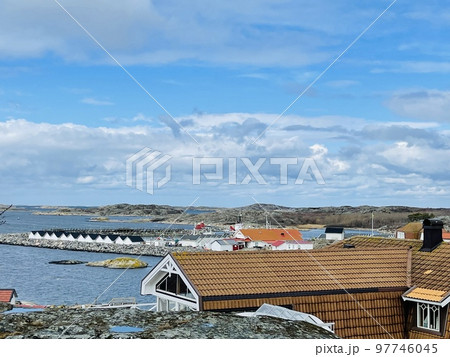 A view of red wooden houses on Vrango Archipelago island . 97746045