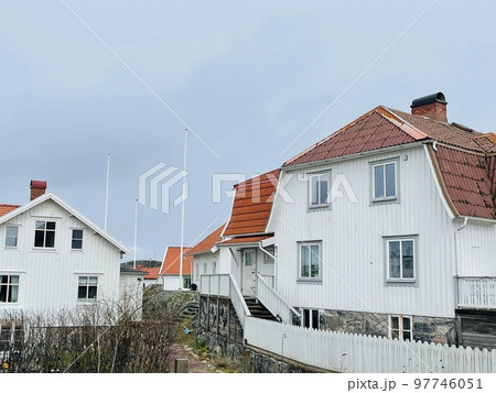 A view of red wooden houses on Vrango Archipelago island . A view of red wooden houses on Vrango Archipelago island . 97746051