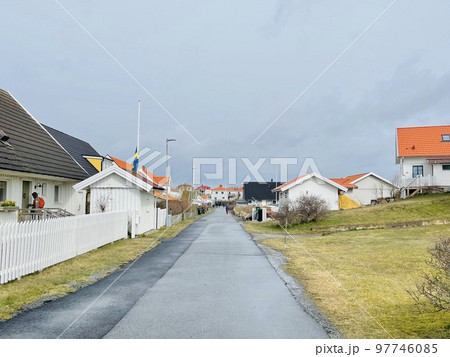 A view of red wooden houses on Vrango Archipelago island . A view of red wooden houses on Vrango Archipelago island . 97746085