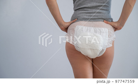 Rear view of a woman in adult diapers. Incontinence problem. 97747559